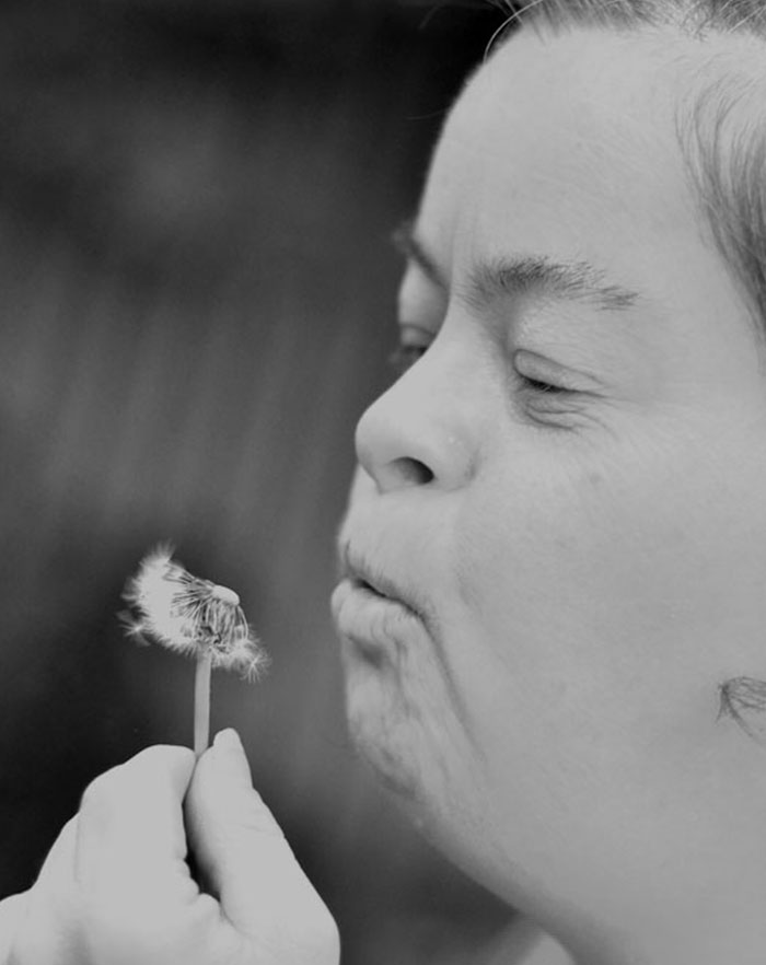 Girl Blowing dandelion